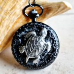 Turtle pocket watch battery operated in black.